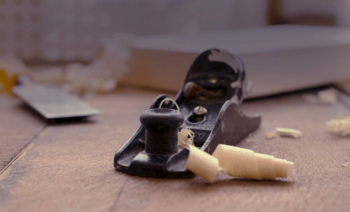 A precision-aligned woodworking fence for miter saw mounted on a DeWalt DWS780, showing laser-etched reference marks and a digital caliper measuring zero clearance at both front and rear